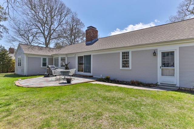 56 Fairwood Rd, South Yarmouth, MA 02664 - back of house featuring a lawn, a chimney, roof with shingles, and a patio