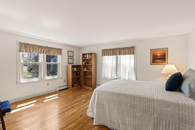 56 Fairwood Rd, South Yarmouth, MA 02664 - bedroom with baseboard heating and wood finished floors
