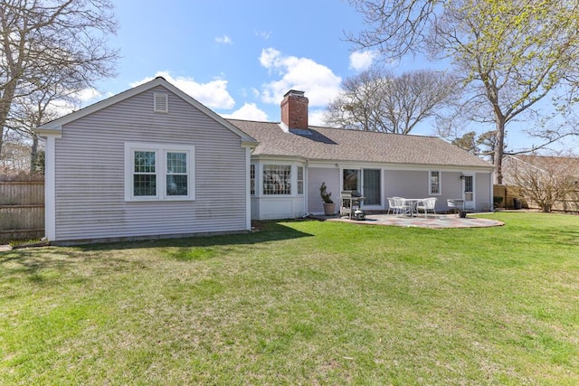 56 Fairwood Rd, South Yarmouth, MA 02664 - rear view of house with a yard, a patio area, a chimney, and fence