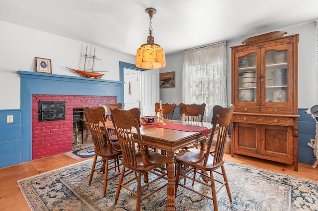 dining room featuring a brick fireplace