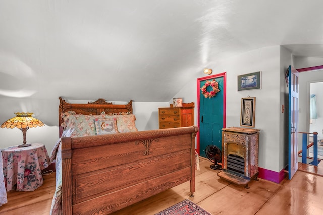 bedroom featuring wood-type flooring and vaulted ceiling