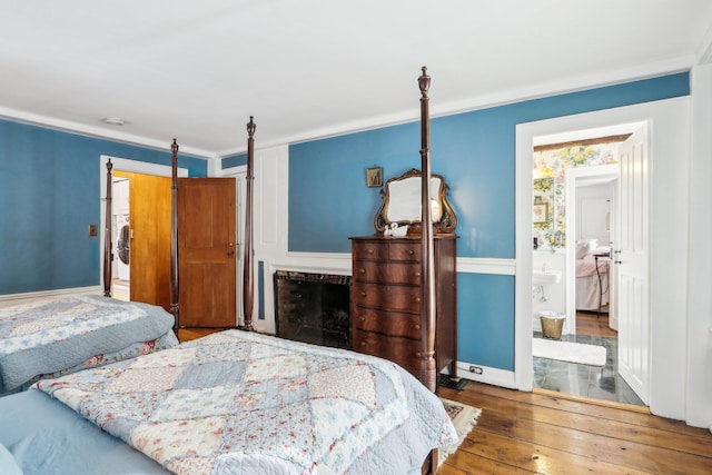 100 Eliot St, Natick, MA 01760 - bedroom featuring crown molding, stacked washer / drying machine, and hardwood / wood-style floors
