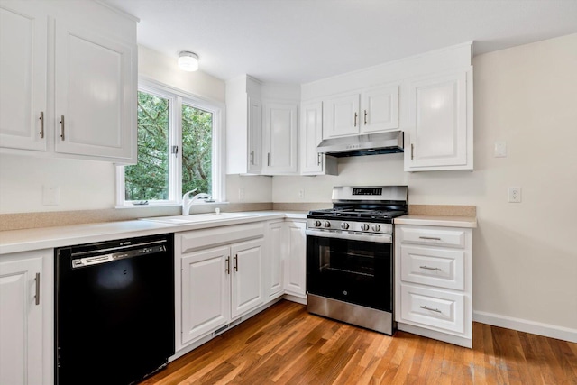 31 John Joseph Rd, Harwich, MA 02645 - kitchen with stainless steel gas range oven, black dishwasher, under cabinet range hood, white cabinets, and light wood finished floors