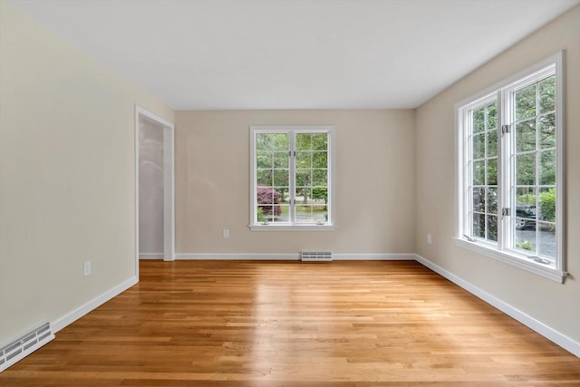 31 John Joseph Rd, Harwich, MA 02645 - empty room with plenty of natural light, light wood-style flooring, and a baseboard heating unit
