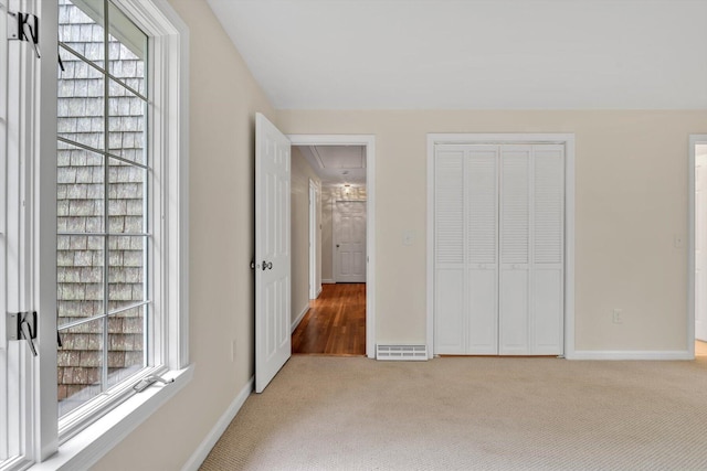 31 John Joseph Rd, Harwich, MA 02645 - unfurnished bedroom featuring attic access, carpet flooring, multiple windows, and a closet