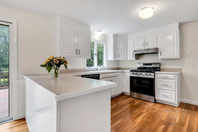 31 John Joseph Rd, Harwich, MA 02645 - kitchen featuring stainless steel range with gas cooktop, under cabinet range hood, a peninsula, and white cabinets