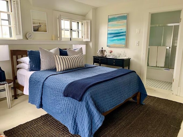 tiled bedroom with vaulted ceiling and connected bathroom