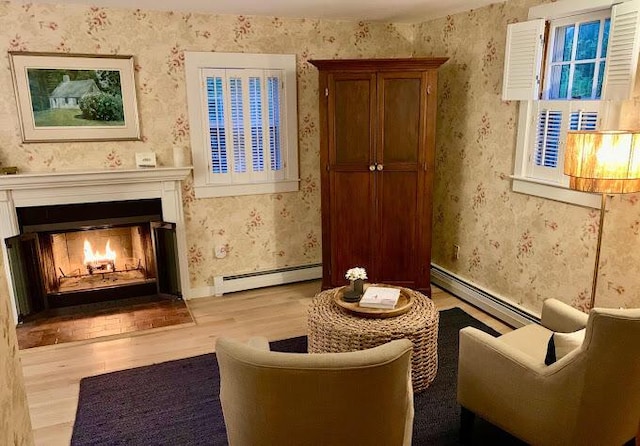 sitting room with light wood-type flooring and a baseboard radiator