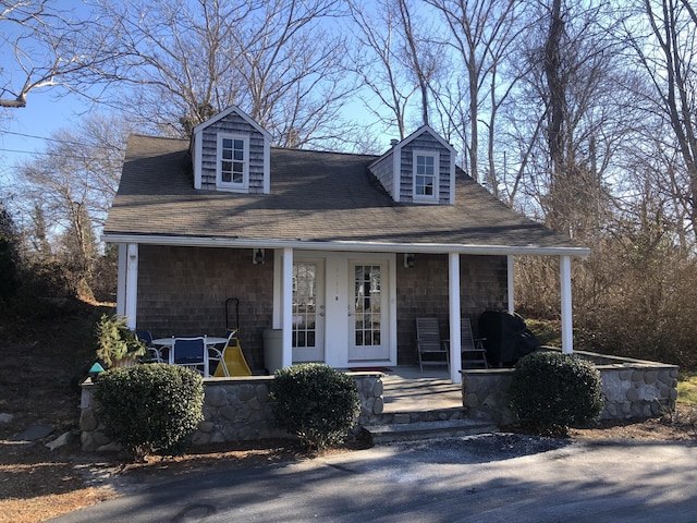 cape cod-style house with a porch