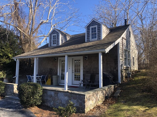 cape cod-style house with a porch