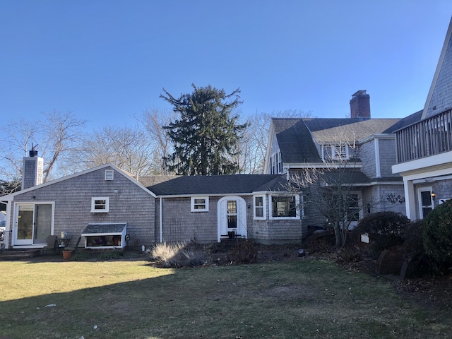 view of front of property featuring a balcony and a front lawn