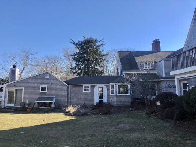 view of front of house featuring a balcony and a front yard