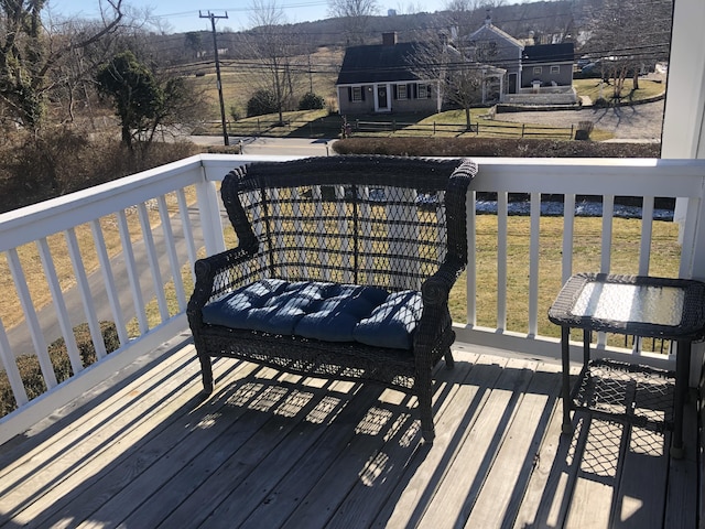 wooden terrace featuring a lawn