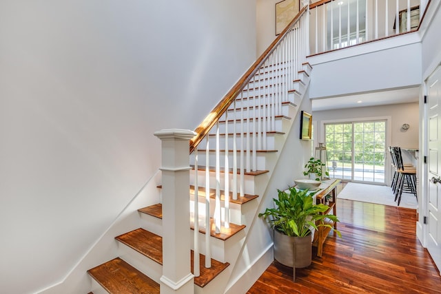 2016 Main St, Chatham, MA 02633 - staircase featuring wood finished floors, a towering ceiling, and baseboards