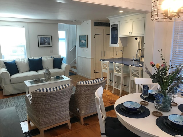 5 Milestone Way, Mashpee, MA 02649 - dining room featuring a wainscoted wall, stairs, a notable chandelier, and light wood finished floors