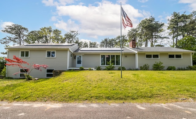 218 Center St, South Dennis, MA 02660 - single story home with solar panels, a chimney, and a front lawn