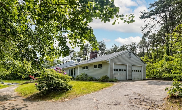 218 Center St, South Dennis, MA 02660 - view of home's exterior featuring a chimney and a lawn