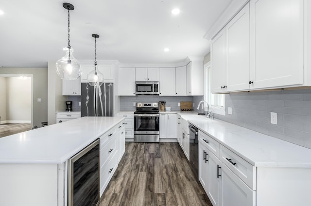 218 Center St, South Dennis, MA 02660 - kitchen with appliances with stainless steel finishes, wine cooler, a sink, dark wood-type flooring, and light countertops