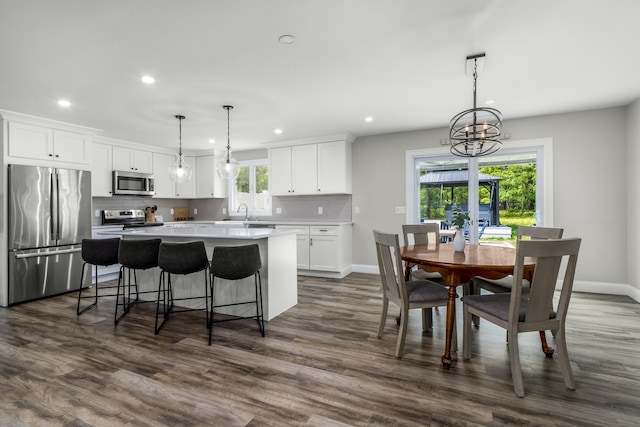 218 Center St, South Dennis, MA 02660 - kitchen with appliances with stainless steel finishes, recessed lighting, a center island, white cabinetry, and a sink