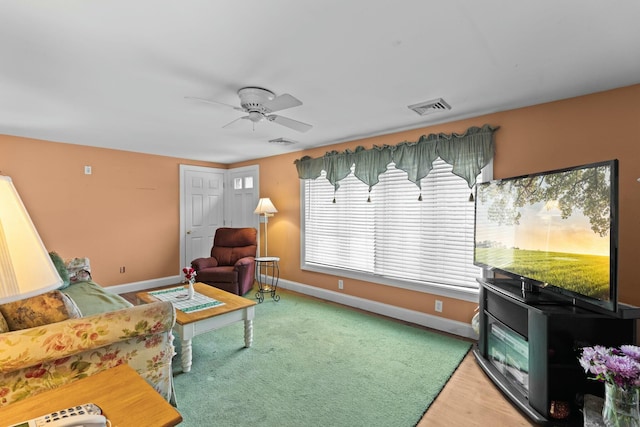 interior space featuring visible vents, ceiling fan, and baseboards