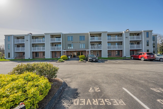view of building exterior featuring uncovered parking