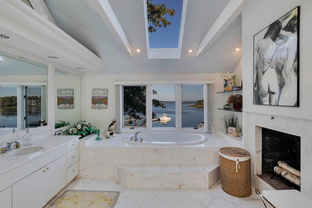 169 Daniels Island Rd, Mashpee, MA 02649 - full bath featuring vaulted ceiling with skylight, a bath, vanity, marble finish floor, and recessed lighting