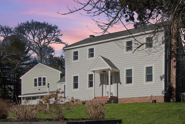 colonial inspired home with a front lawn