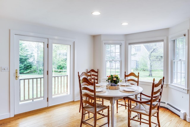dining space with light wood-style floors and recessed lighting