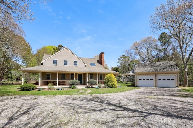 view of front of property featuring covered porch, a chimney, an attached garage, and driveway
