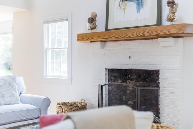 living room featuring a brick fireplace