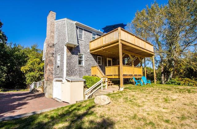 back of property with a lawn and a deck