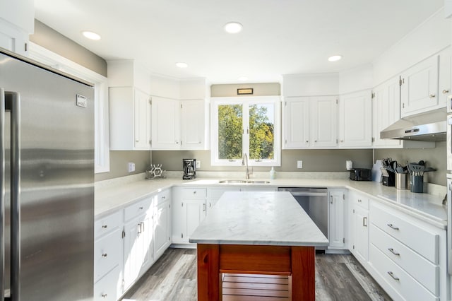 kitchen with sink, white cabinetry, dark hardwood / wood-style floors, and stainless steel appliances