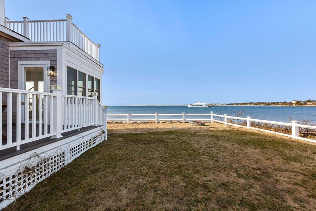 view of yard with a water view and fence