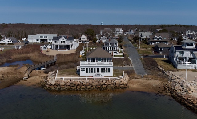 drone / aerial view featuring a residential view and a water view