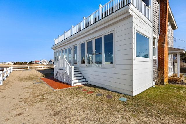 view of home's exterior with fence