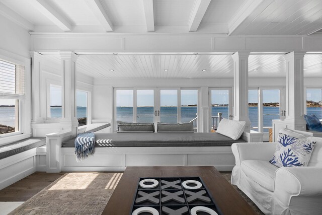 sunroom / solarium featuring a wealth of natural light, a water view, and beam ceiling