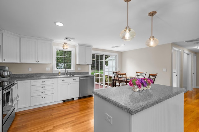 69 Joan Rd, Centerville, MA 02632 - kitchen with stainless steel appliances, white cabinetry, light wood finished floors, pendant lighting, and recessed lighting