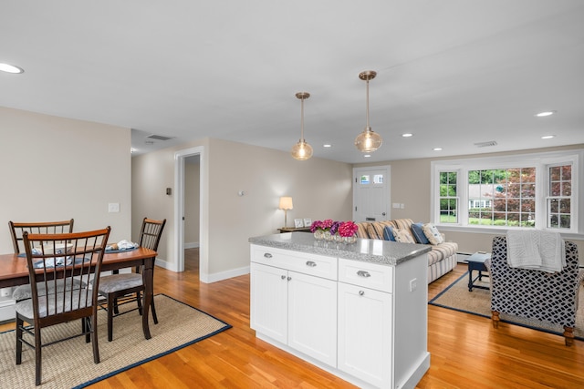 69 Joan Rd, Centerville, MA 02632 - kitchen featuring light wood-type flooring, white cabinets, a kitchen island, hanging light fixtures, and recessed lighting