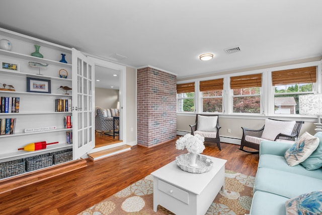 69 Joan Rd, Centerville, MA 02632 - living area featuring wood finished floors and a baseboard heating unit