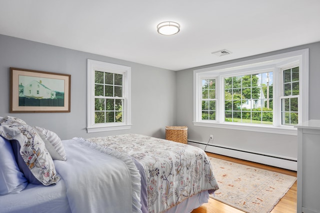 69 Joan Rd, Centerville, MA 02632 - bedroom with baseboard heating and wood finished floors