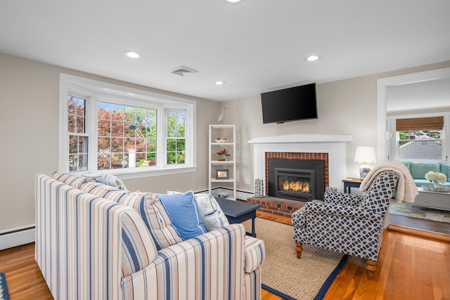 69 Joan Rd, Centerville, MA 02632 - living area featuring light wood-type flooring, a brick fireplace, baseboard heating, and recessed lighting