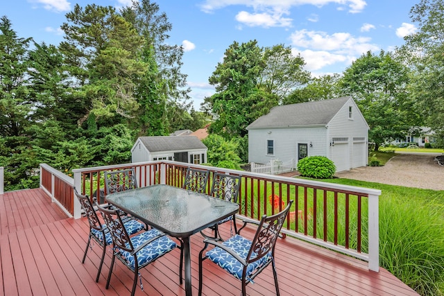 69 Joan Rd, Centerville, MA 02632 - deck featuring an outdoor structure, outdoor dining space, a yard, and a detached garage