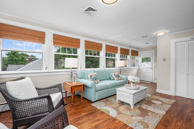 69 Joan Rd, Centerville, MA 02632 - living room featuring healthy amount of natural light, crown molding, and wood finished floors