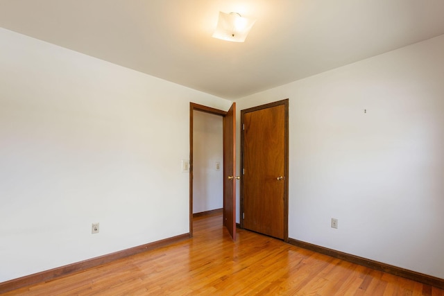 unfurnished room featuring light wood-type flooring and baseboards