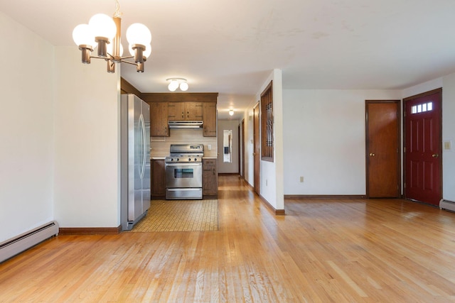 kitchen with stainless steel appliances, a baseboard radiator, under cabinet range hood, light wood-style flooring, and baseboards