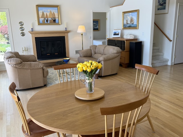15 Hidden Valley Way, Wellfleet, MA 02667 - dining room featuring stairway, light wood-style flooring, and a glass covered fireplace