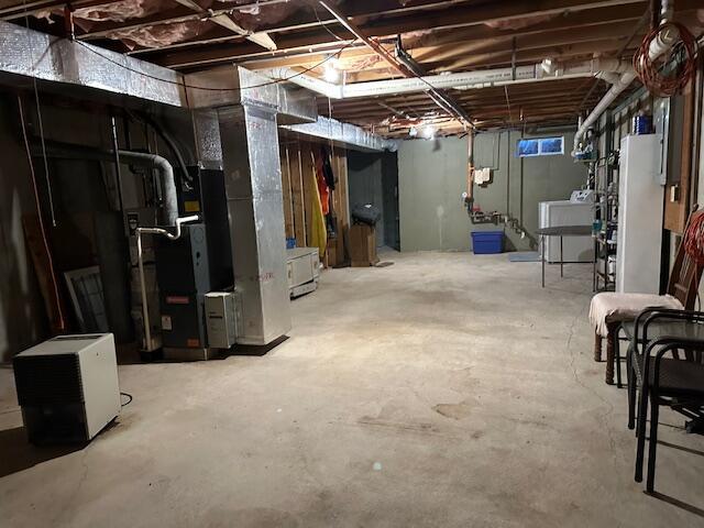 basement featuring washer / dryer and fridge