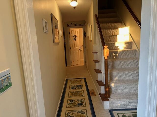 corridor with light tile patterned flooring