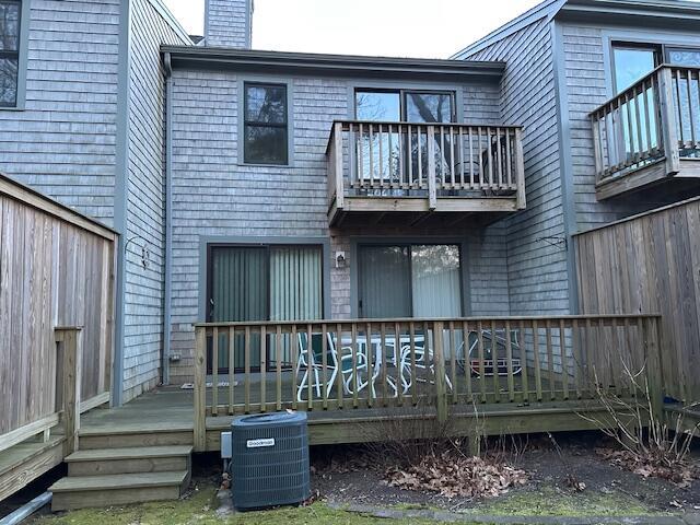 back of house featuring a wooden deck and central AC