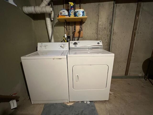 clothes washing area with separate washer and dryer